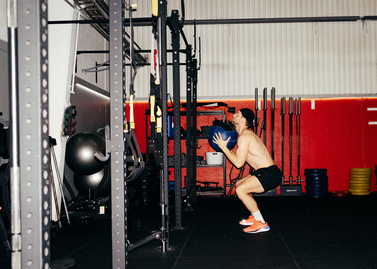A man doing wall balls in TOQO shorts